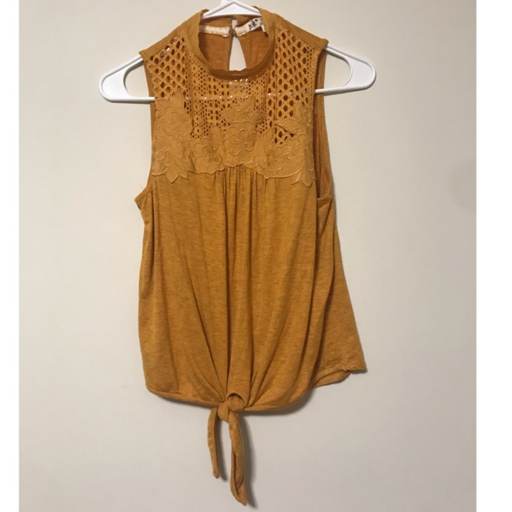 A mustard / orange colored shirt.